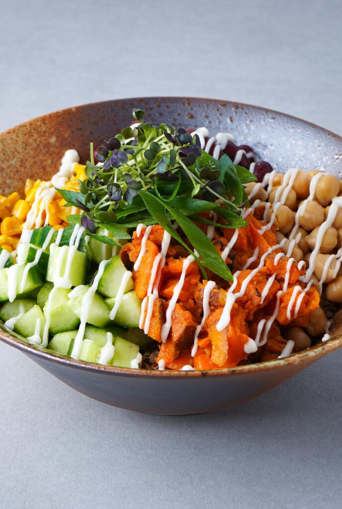 Gesunde Schrankerl Bowl mit Süßkartoffeln, Gurken und Kichererbsen als frische Mitarbeiterverpflegung.